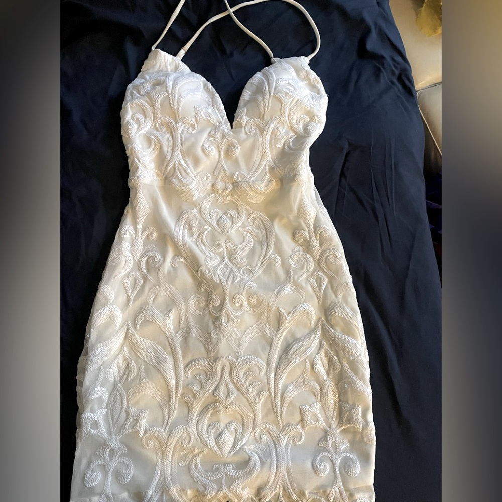 White mini dress, sequin-mesh fabric, spaghetti straps that are adjustable.